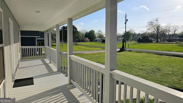 214 Harris St, Chatsworth, GA 30705 - wooden deck featuring a lawn and covered porch