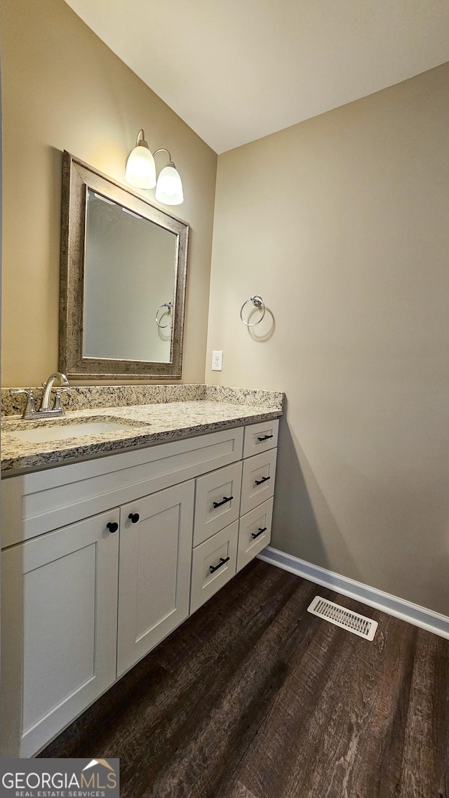 214 Harris St, Chatsworth, GA 30705 - bathroom featuring baseboards, visible vents, wood finished floors, and vanity