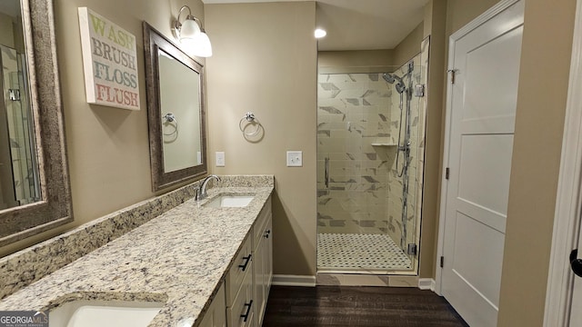 214 Harris St, Chatsworth, GA 30705 - bathroom with double vanity, a sink, a stall shower, and wood finished floors