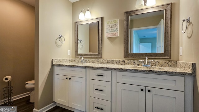 214 Harris St, Chatsworth, GA 30705 - bathroom with toilet, a sink, double vanity, and baseboards