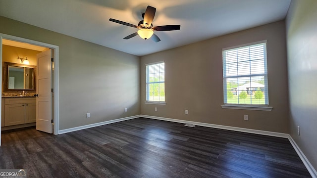214 Harris St, Chatsworth, GA 30705 - unfurnished bedroom with baseboards, a sink, dark wood-style floors, ensuite bath, and ceiling fan