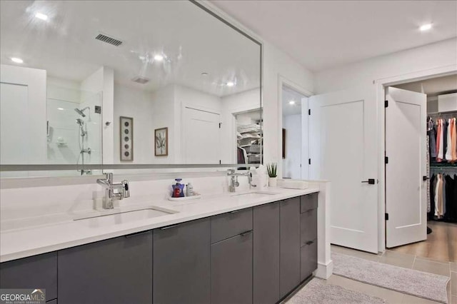 bathroom featuring vanity and a shower with door