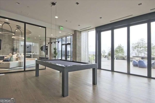 recreation room featuring french doors, a wall of windows, hardwood / wood-style floors, and billiards