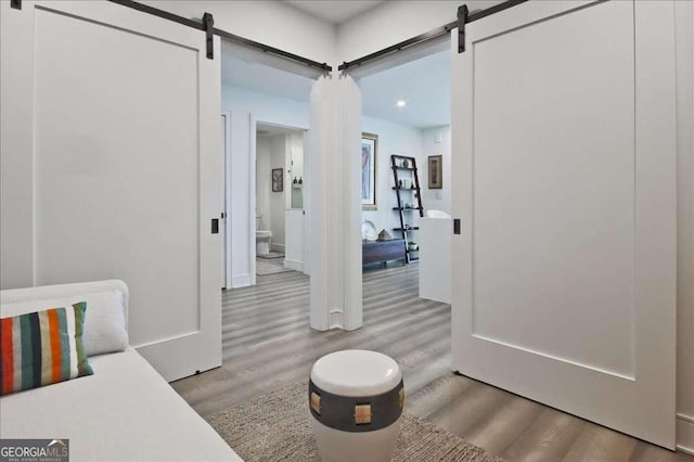 interior space with light hardwood / wood-style floors and a barn door