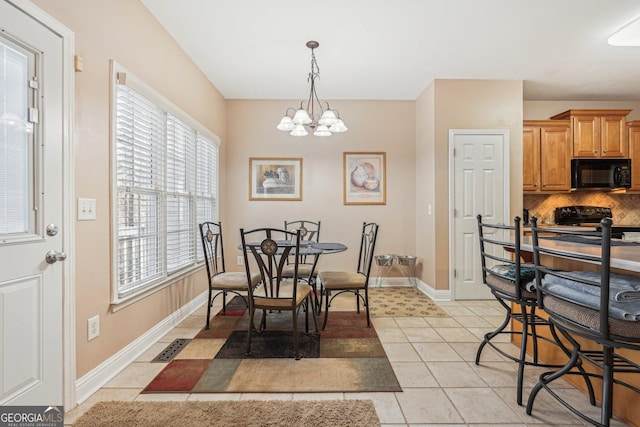 dining space featuring light tile patterned floors, baseboards, visible vents, and a notable chandelier