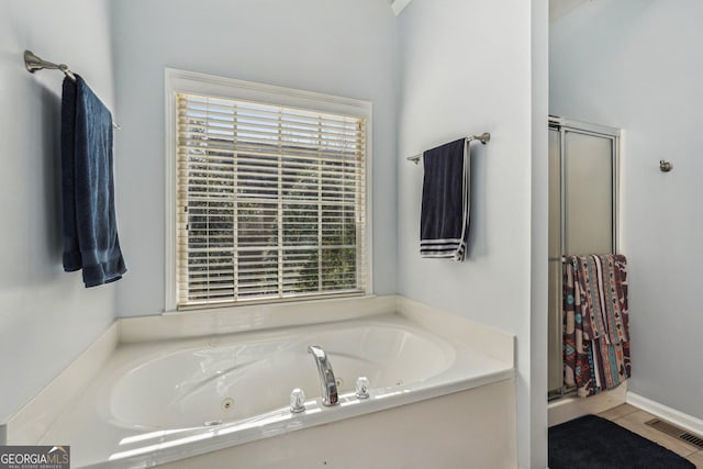 full bath with tile patterned flooring, visible vents, a jetted tub, and a shower stall