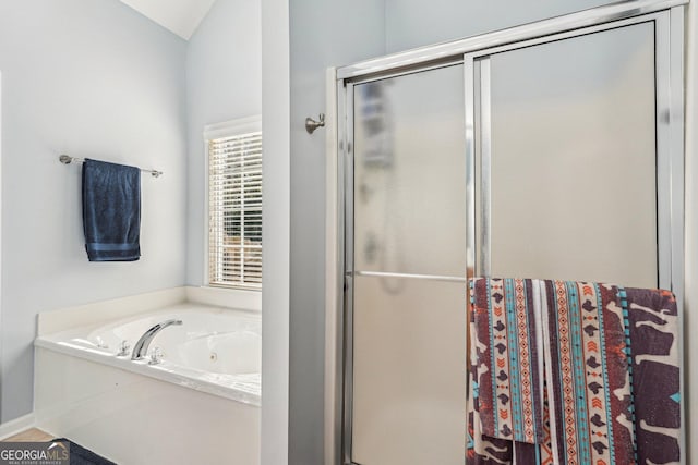 full bathroom with a whirlpool tub and a shower stall