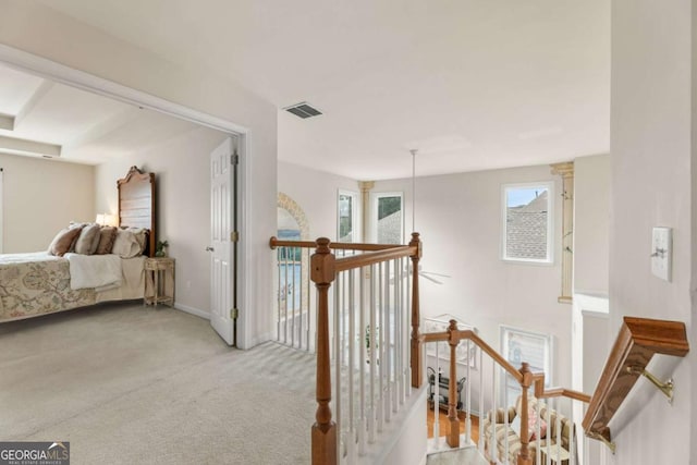 corridor with light colored carpet