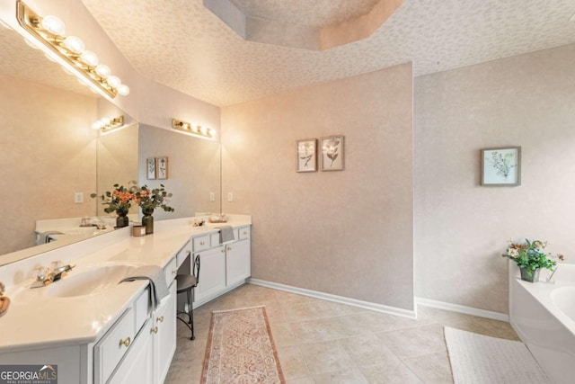 bathroom with vanity, tile patterned floors, a textured ceiling, and a tub to relax in