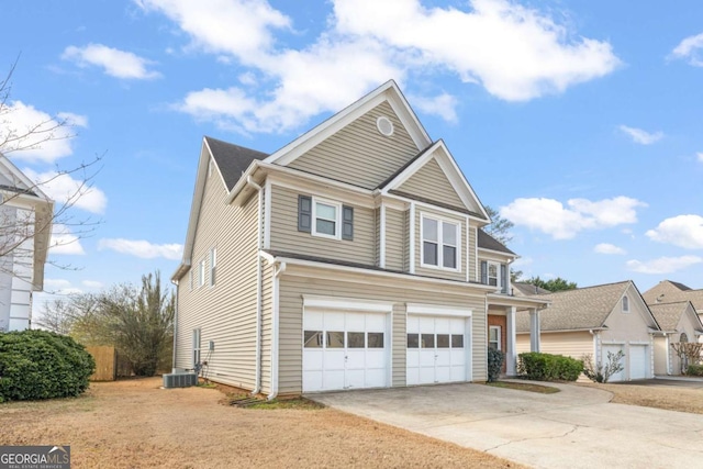 view of front of house with a garage and central air condition unit