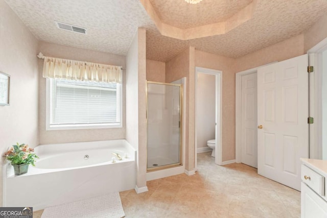 full bathroom with vanity, toilet, independent shower and bath, and a textured ceiling