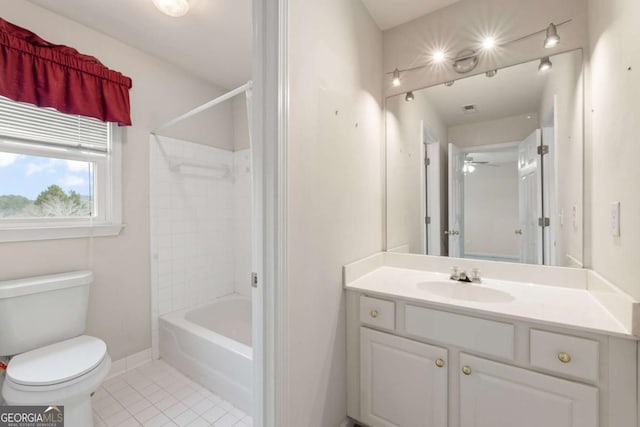 full bathroom featuring tiled shower / bath combo, vanity, tile patterned floors, and toilet