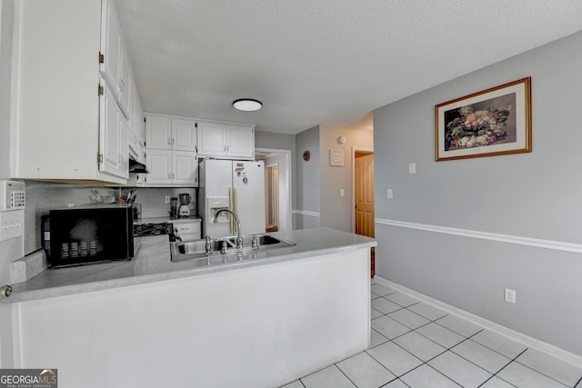 kitchen featuring sink, white fridge with ice dispenser, a textured ceiling, white cabinets, and light tile patterned flooring