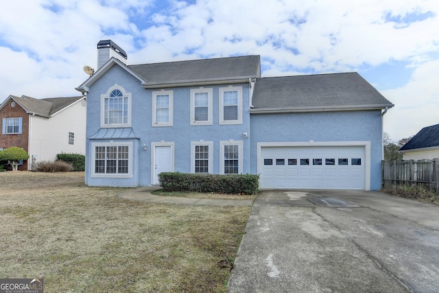 view of front facade with a garage and a front lawn