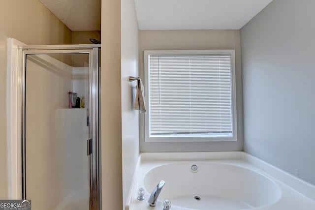 bathroom with separate shower and tub and a textured ceiling