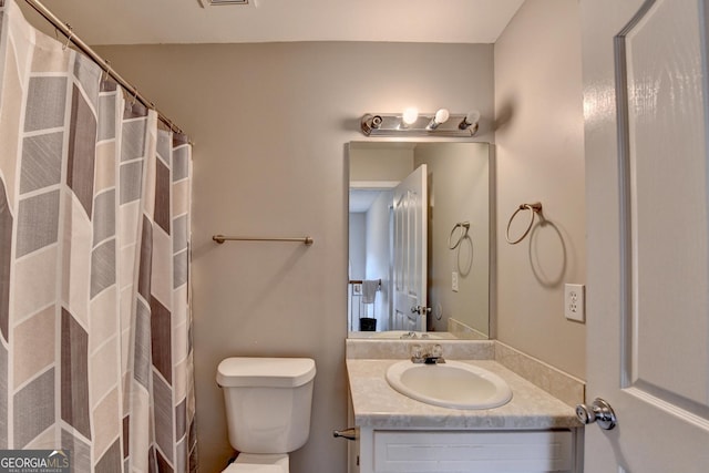 bathroom featuring vanity and toilet