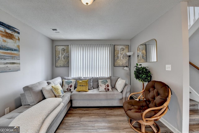 living room featuring hardwood / wood-style floors and a textured ceiling