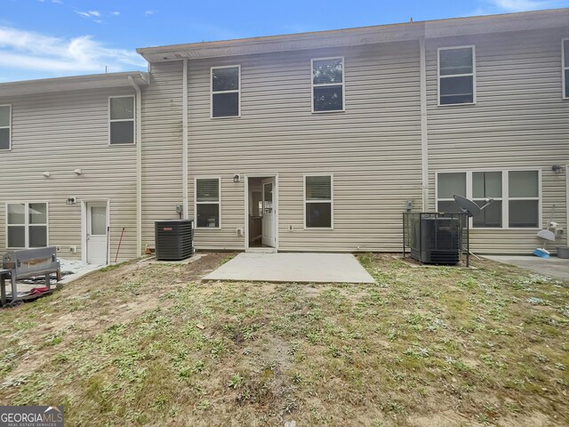 back of house featuring a patio, a yard, and cooling unit