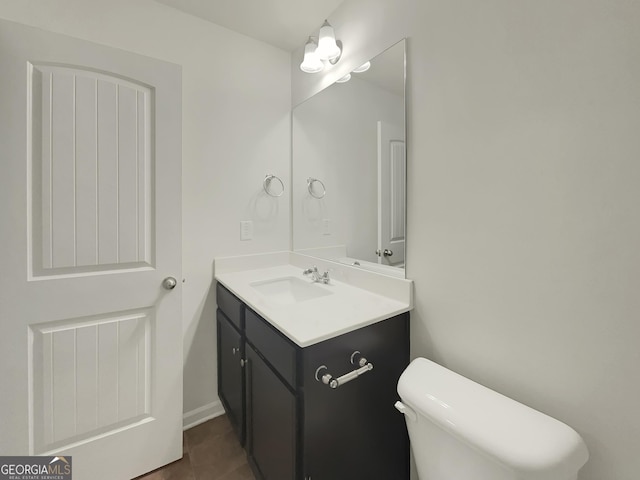 bathroom with vanity, tile patterned floors, and toilet