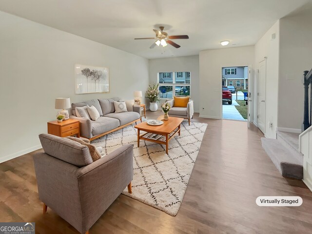 living room with ceiling fan and light hardwood / wood-style flooring