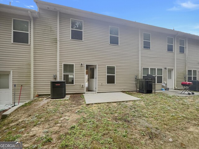 rear view of property with a patio, a yard, and cooling unit