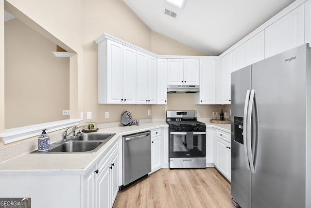 kitchen with lofted ceiling, sink, light hardwood / wood-style flooring, appliances with stainless steel finishes, and white cabinets