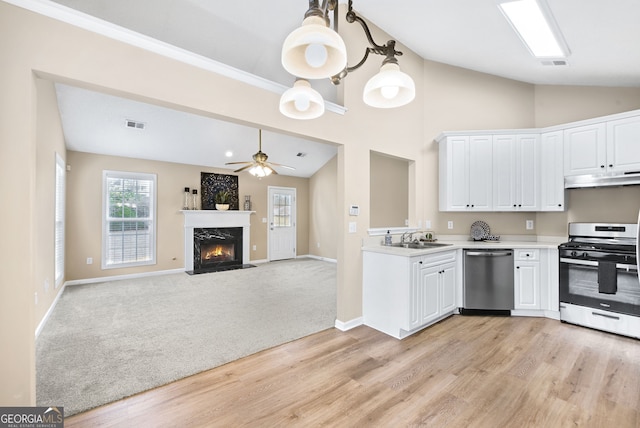 kitchen featuring white cabinetry, stainless steel appliances, vaulted ceiling, and sink