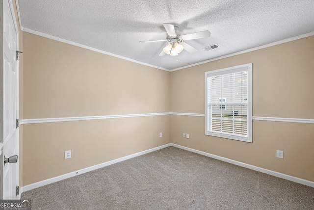 carpeted spare room featuring ceiling fan, ornamental molding, and a textured ceiling