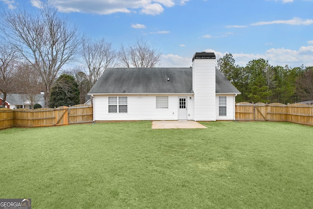 rear view of house with a yard and a patio area