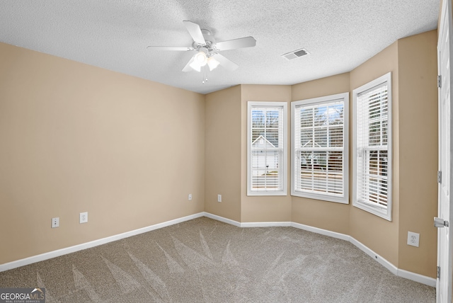 carpeted empty room with a textured ceiling and ceiling fan