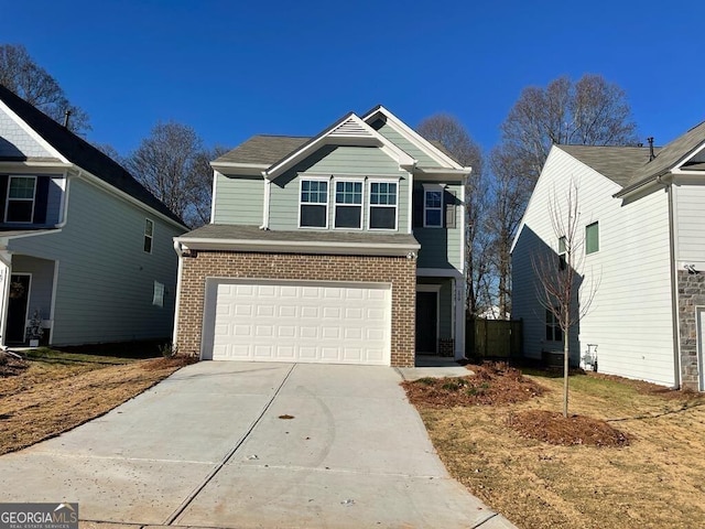 view of front of home with an attached garage, concrete driveway, and brick siding