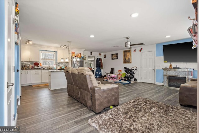 living room featuring hardwood / wood-style floors and ceiling fan