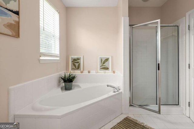 bathroom with tile patterned flooring and independent shower and bath