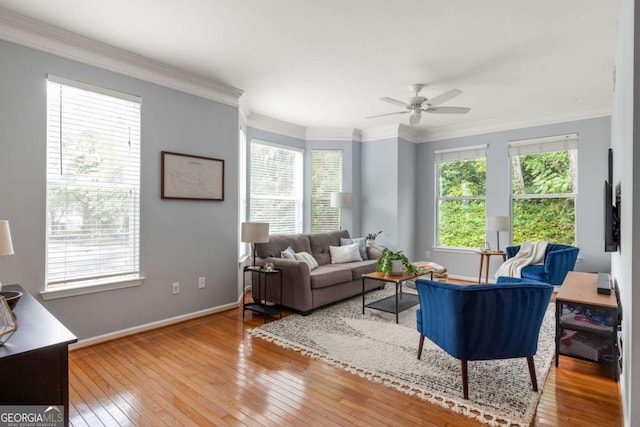 living room with ornamental molding, hardwood / wood-style floors, and ceiling fan