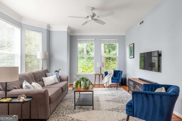 living room featuring crown molding, ceiling fan, and light hardwood / wood-style flooring