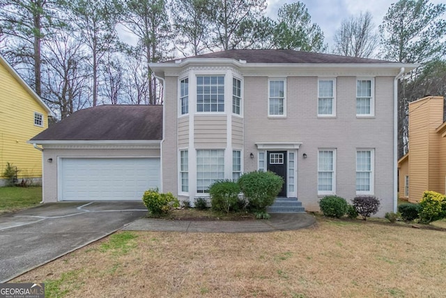 view of front of house featuring a garage and a front yard