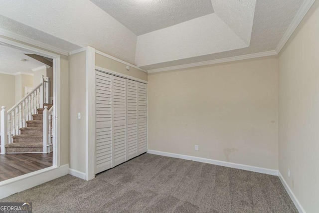 unfurnished bedroom with crown molding, a textured ceiling, and carpet