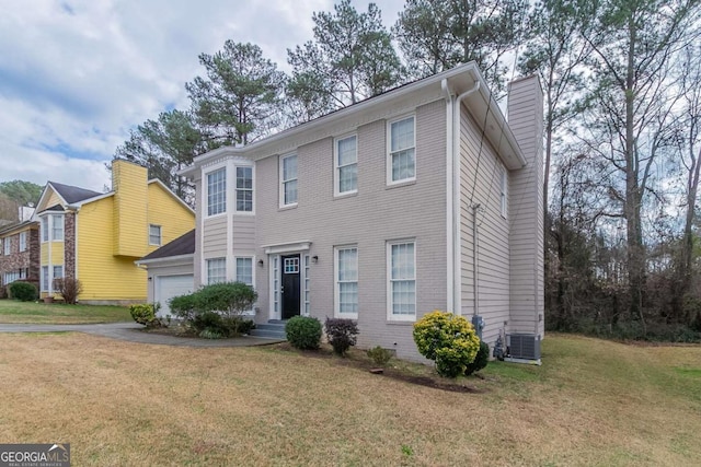 colonial inspired home featuring cooling unit, a garage, and a front lawn