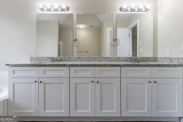 bathroom featuring vanity and a bathing tub