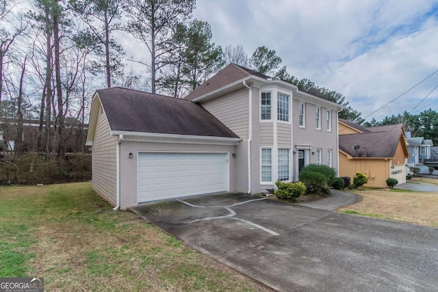 view of front of house featuring a garage and a front lawn