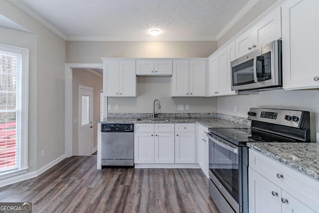 kitchen featuring stainless steel appliances, sink, white cabinets, and dark hardwood / wood-style flooring