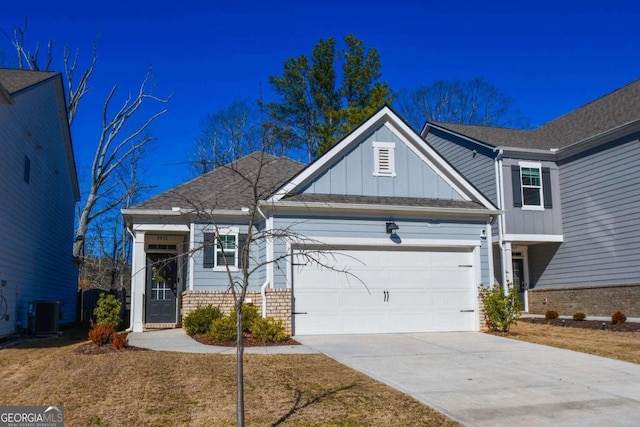 view of front of house featuring a garage and central AC unit