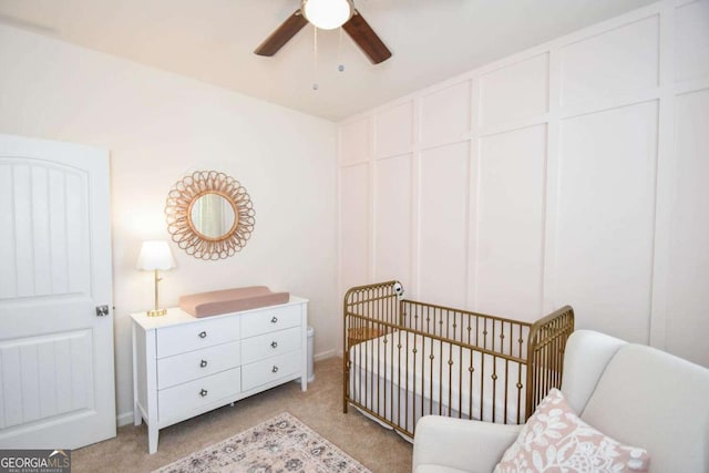 carpeted bedroom featuring a crib