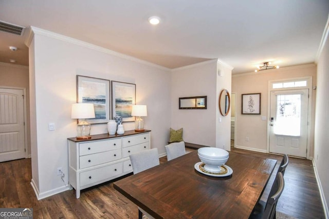 dining space featuring ornamental molding and dark hardwood / wood-style floors