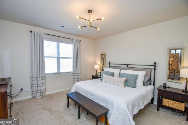 carpeted bedroom with a chandelier