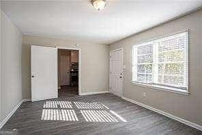 empty room with dark hardwood / wood-style flooring