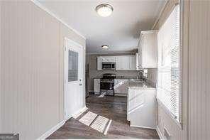 kitchen featuring white cabinetry, sink, dark hardwood / wood-style floors, and appliances with stainless steel finishes