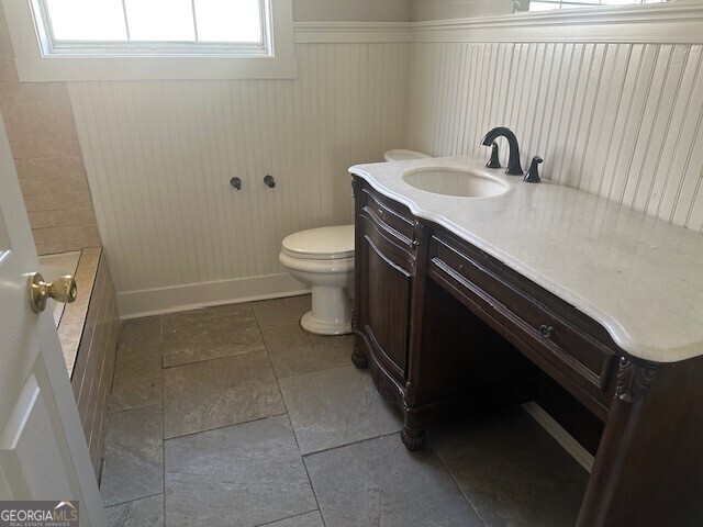 bathroom featuring vanity and toilet