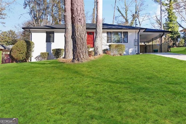 ranch-style home featuring a carport and a front yard