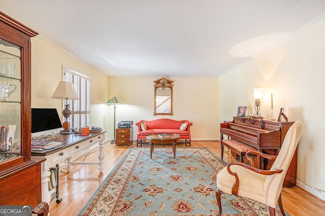 living room with baseboards, ornamental molding, and wood finished floors